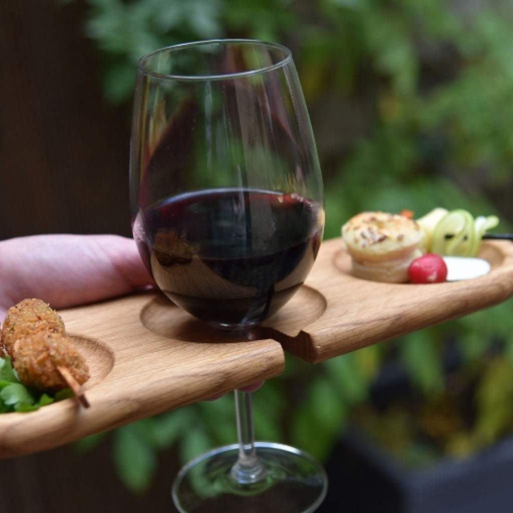 Cocktail Plate Glass Holder hold by hand with food and Glass of Red Wine